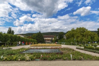 Doblhoffpark with Weikersdorf Castle, flower beds and fountains under a cloudy sky, Baden, Lower