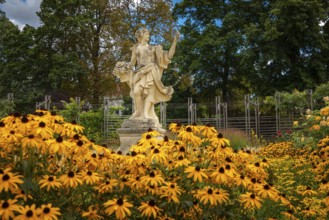 Statue of the goddess Flora surrounded by yellow coneflower (Echinacea), Doblhoffpark, Baden, Lower
