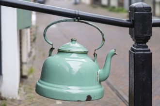 Old enamel tea or water kettle, decoration in front of a tea shop, province of Groningen,