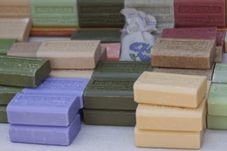 Market stall with various soaps, weekly market market Asciano, Tuscany, Italy