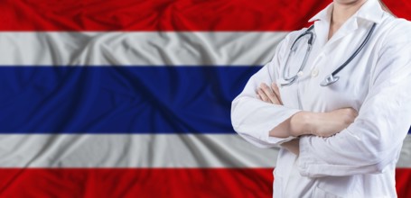 Doctor with crossed arms on Thailand flag. Thai health and care concept. Female doctor on Thailand