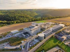 Large-scale building complex inspired by natural surroundings with hills and fields, new hospital