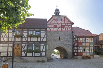 Historic Lower Tor with spire and clock and colourful half-timbered houses, Tor tor, town gate,