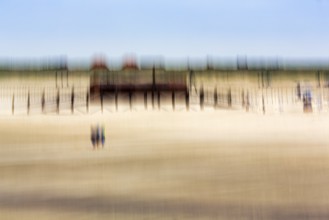 Three people on the North Sea beach, pile dwelling, stilt house, architecture, wipe effect, long