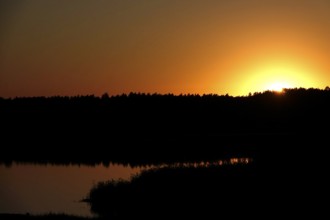 Landscape with lake, rising sun, August, Saxony, Germany
