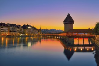 Chapel bridge with water tower reflected in the river Reuss, Lucerne old town at dawn, Canton