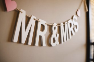 Close up of Mr & Mrs wedding garland with hearts. Romantic wedding decoration detail. Generative