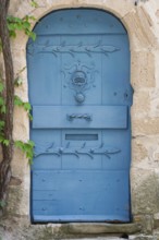 Blue door in a historic house façade, Vaison-la-Romaine, Provence, France