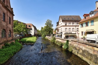 Ettlingen, Germany - August 13th 2025: Alb brook in historic center of Ettlingen, Germany. Small
