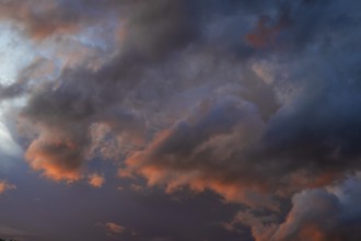 Clouds illuminated by the sun in the evening sky, Bavaria, Germany