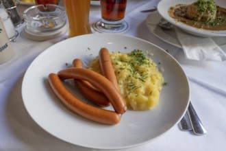 Viennese sausages with potato salad served in a beer garden, Bavaria, Germany