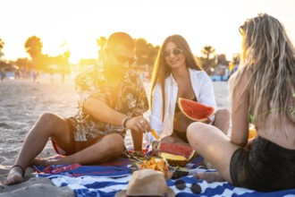 Friends sharing laughter and enjoying juicy watermelon and sweet pineapple during a picturesque
