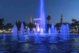 Majestic mosque providing a backdrop to illuminated fountains, creating a captivating scene in