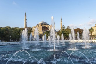 Fountains splashing water in front of the hagia sophia in istanbul, turkey, during a sunny day
