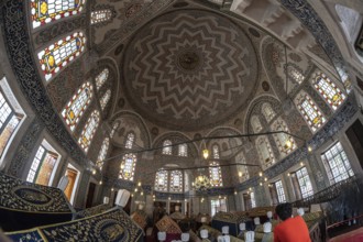 Wide angle view of the ornate ceiling and stained glass windows inside suleymaniye mosque, a