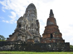 Crumbling ancient buddhist temple wat ratchaburana with ornate prang and damaged stupa, displaying