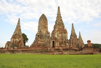 Scenic view of the historical wat chaiwatthanaram temple with its towering prangs and serene green