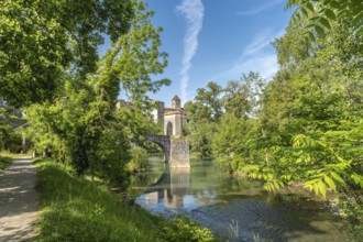 Scenic view of the historic stone bridge spanning the gave d'oloron river, with lush green foliage