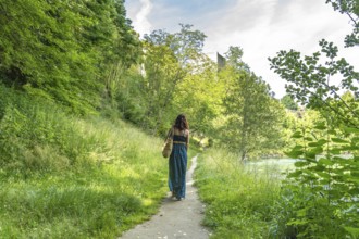 Tourist enjoying summer holidays walking along gave d'oloron river in sauveterre de bearn, a