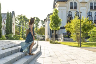 Young woman descending stairs in salies de bearn, a picturesque village in the pyrenees atlantiques