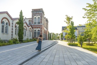 Woman strolling through salies de bearn, enjoying the charming architecture and tranquil atmosphere