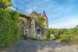 Tourist walking in the beautiful medieval village of sauveterre de bearn, in the pyrenees