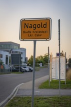 Town sign of Nagold on a street with modern buildings in the background, Nagold, district of Calw,