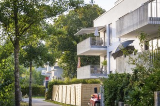 Modern residential building with balconies and trees, sunny summer day, Nagold, district of Calw,
