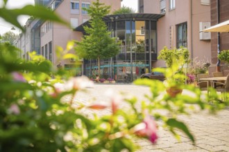 Street scene with a modern building surrounded by green vegetation and warm light, Nagold, district