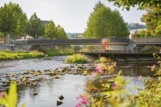 River landscape with bridge and lush vegetation, captured on a sunny summer day, Nagold, district