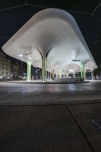 Stylish bus stop at night with illuminated architectural designs, Munich, Germany