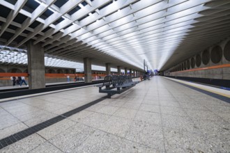 Minimalist railway station with symmetrical design and bright atmosphere, Munich, Germany