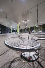 Urban architecture at night with modern seating and interesting lighting, Munich, Germany