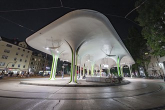 Modern bus stop with striking lighting and structural design elements, Munich, Germany