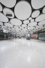 Light-flooded mall with modern round ceiling panels, Munich, Germany