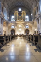 Solemn interior view of a church with altar and organ in the background, Munich, Germany