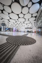 Futuristic airport with round ceiling panels and modern ambience, Munich, Germany