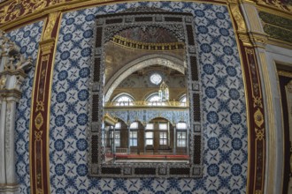 Luxurious mirror reflecting the ornate interior of a room in topkapi palace, showcasing ottoman
