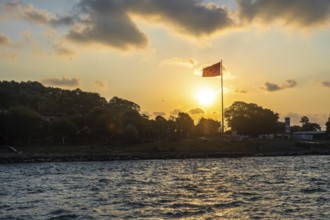 Turkish flag waving at sunset over the bosphorus strait in istanbul, turkey, creating a scenic view