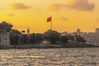 Scenic sunset view of istanbul's cityscape, featuring the prominent galata tower and a waving
