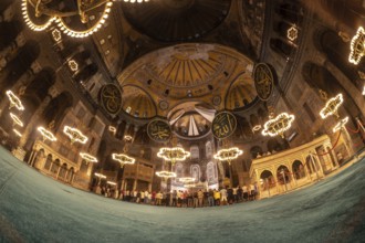 Fisheye view of muslim people praying inside the magnificent hagia sophia grand mosque in istanbul,