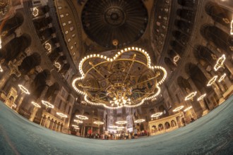 Fisheye view of tourists visiting the magnificent interior of hagia sophia, showcasing its stunning