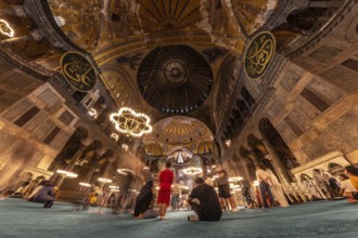 Tourists contemplating the impressive architecture and intricate details of the hagia sophia, a