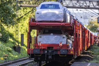 Car train with new cars on the railway line near Stuttgart. The so-called Schusterbahn is a bypass