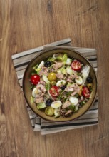 Salad with canned tuna, vegetable salad with quail eggs, lettuce, red onion, cherry tomatoes,