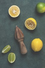 Wooden citrus reamer, manual lemon juicer, made of acacia wood, with citrus fruits on the table,