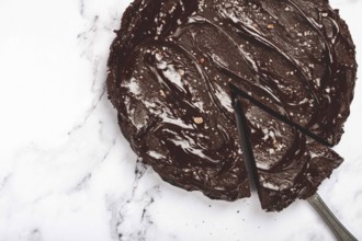 Chocolate cake, round cake, on a marble light table, top view, homemade cakes, no people