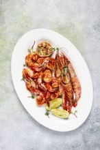 Fried langoustines and tiger shrimps, with spices and herbs, homemade dish, without people