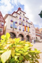 Historic town hall with colourful flags and flowers in the town centre, small town pearl Calw,