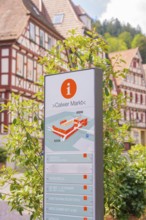 Information sign of the Calw market in front of sunny half-timbered houses, small town of Perle